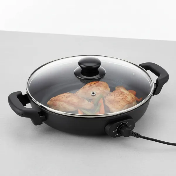 De'Longhi BG45 electric skillet with glass lid, showing spacious cooking surface and controls.