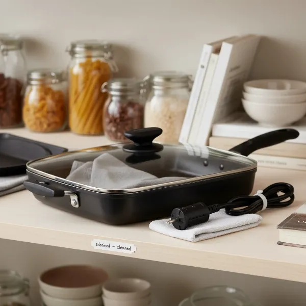 A clean Continental electric skillet being stored with its lid, ready for its next use.