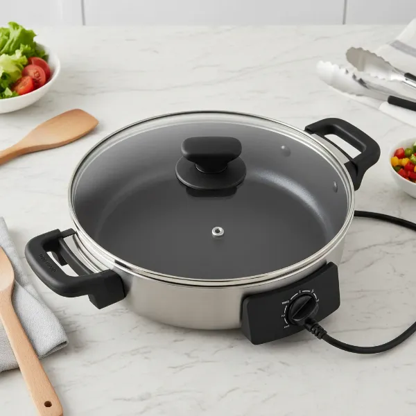 A sleek, modern electric skillet with a prominent non-stick cooking surface, showcasing its integrated heating element and temperature dial.