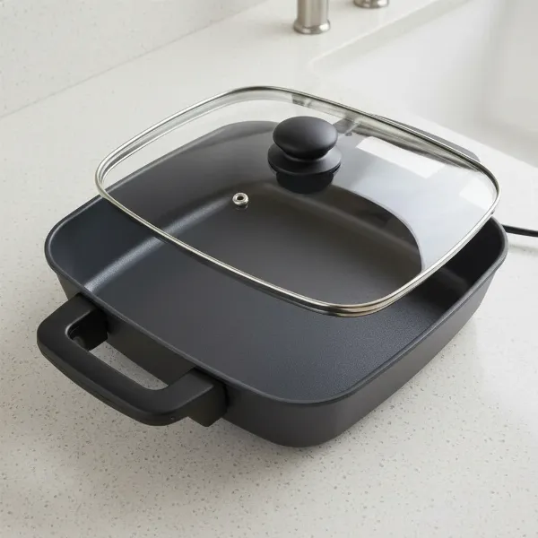 Elite Gourmet 12-inch deep square electric skillet with non-stick surface and glass lid.