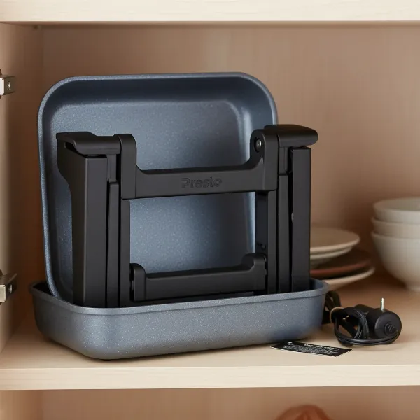Presto Foldaway electric skillet compactly stored with base and handles tucked inside.