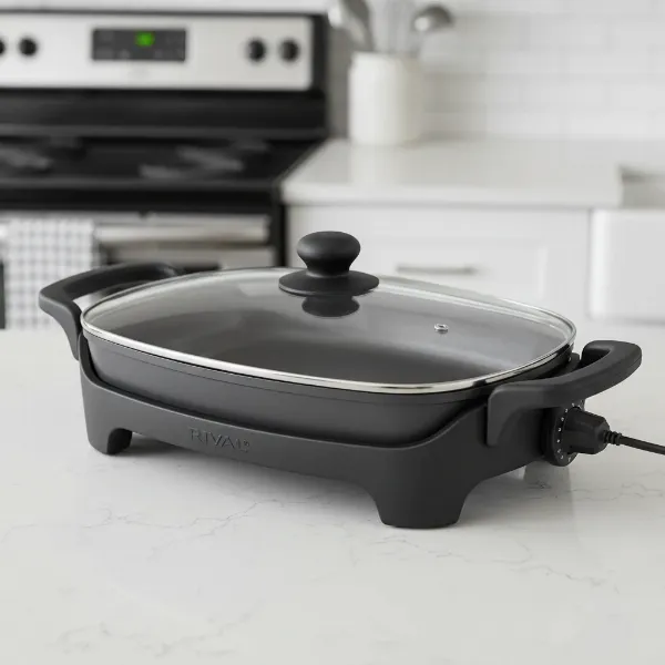 Rival electric skillet with removable non-stick pan, glass lid, and detachable temperature control probe.