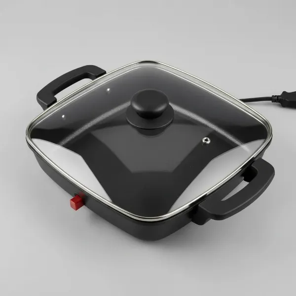 Toastmaster 11-inch electric skillet with square design, high sides, nonstick interior, and clear glass lid.