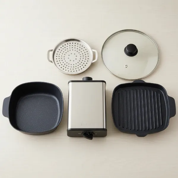 Zojirushi electric skillet displaying interchangeable cooking pans and lid